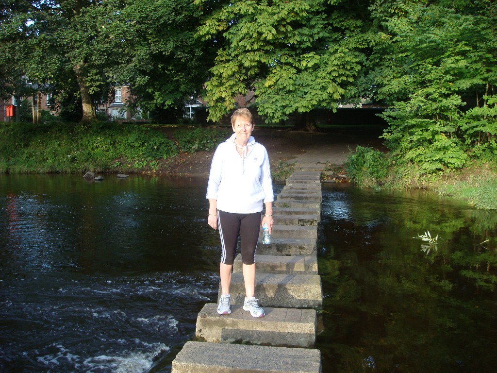 Pam walking across the Wansbeck River, Morpeth.  2011