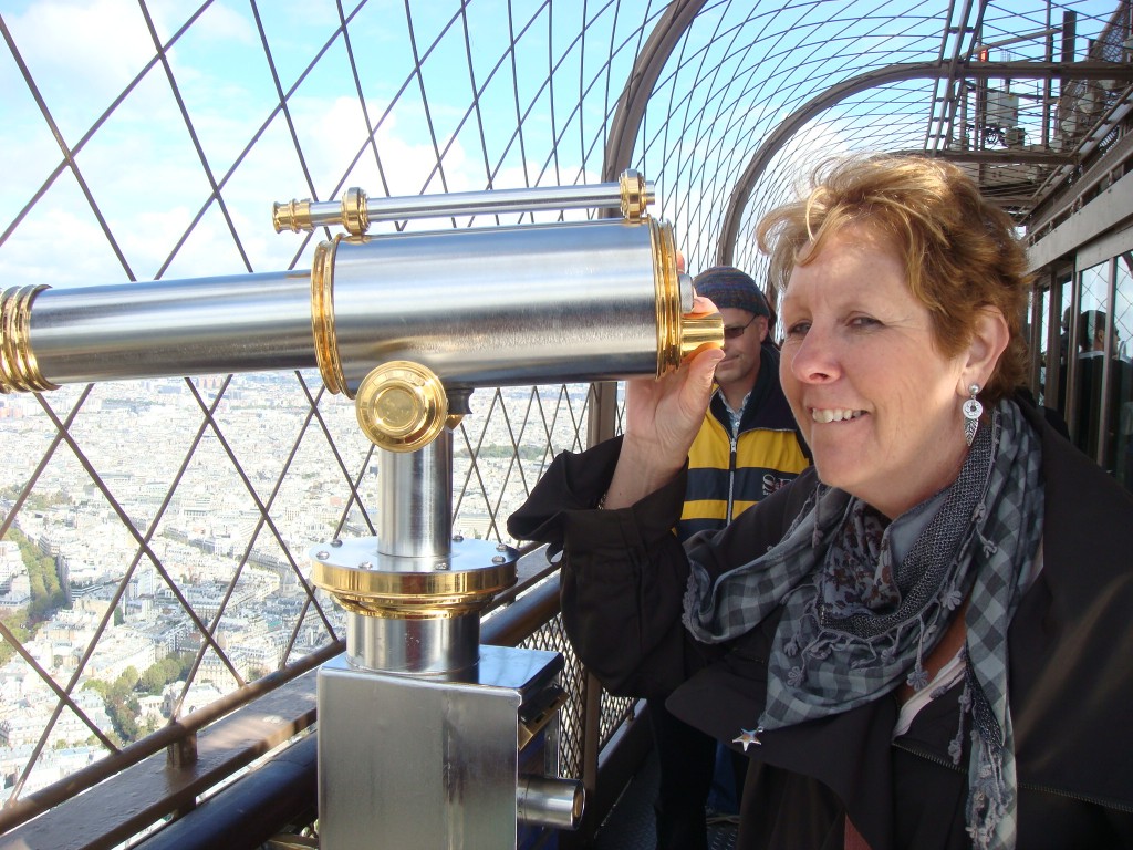 Pam enjoys the view from the top deck of the Eiffel Tower, Paris.  2011