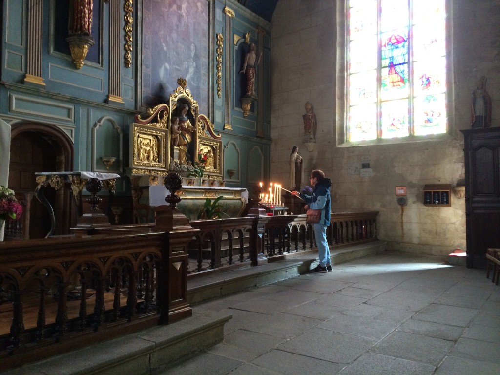 Pam lights another candle, The Notre Dame, Locronan, Brittany.  2014