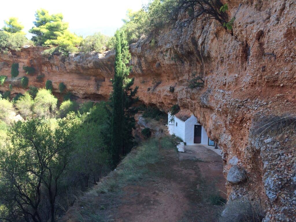 The locals have dug a shaft down through the rock into the sink hole. Steps are cut into the rock, the walls are white washed but it's still a little challenging. The end is worth the wait with this lovely little chapel constructed into the cave.