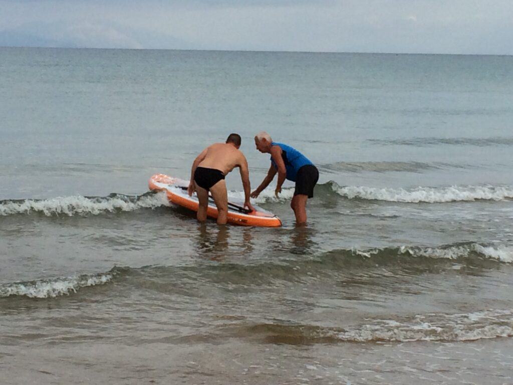 Our Dutch neighbor offers me a lesson on his paddle board.
